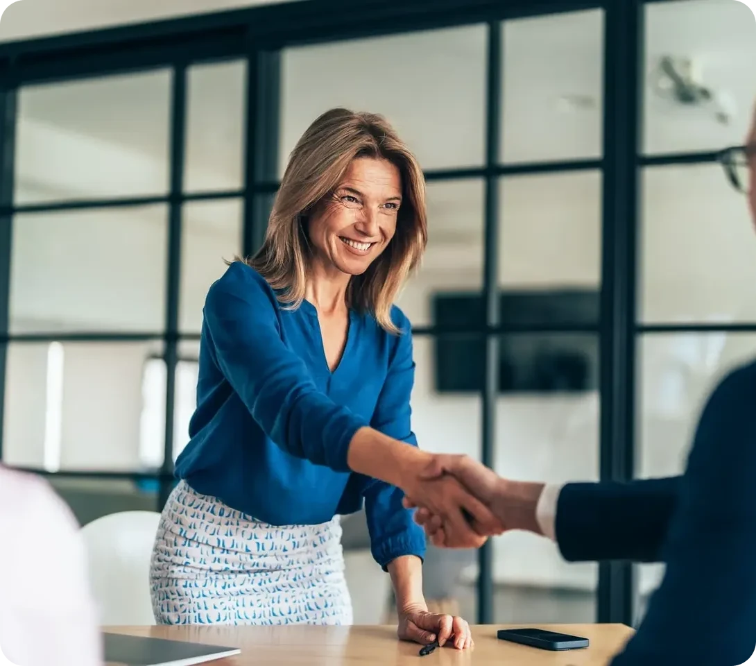 Businesswoman shaking hands in office meeting