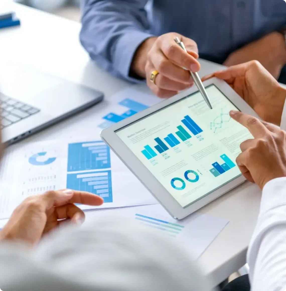 Team reviewing financial graphs on tablet